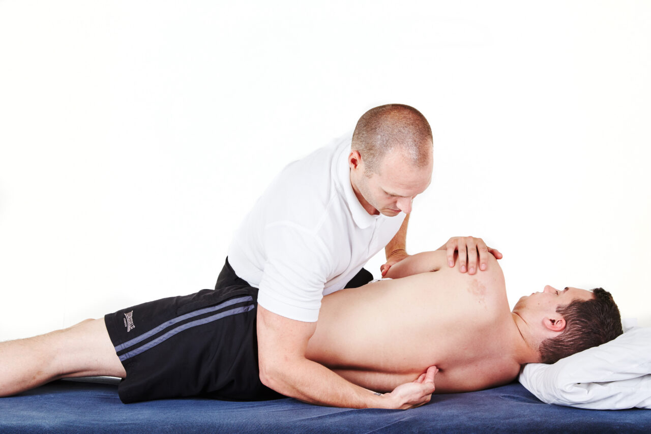 OMT Training osteopath demonstrating hands-on manual therapy with a patient